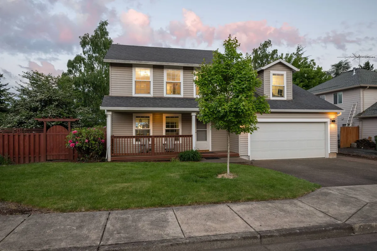 The home's front porch framed by greenery, flowering plants, and a welcoming pathway. The setting radiates comfort and approachability, suggesting a pet-friendly, walkable neighborhood ideal for both people and their furry companions.